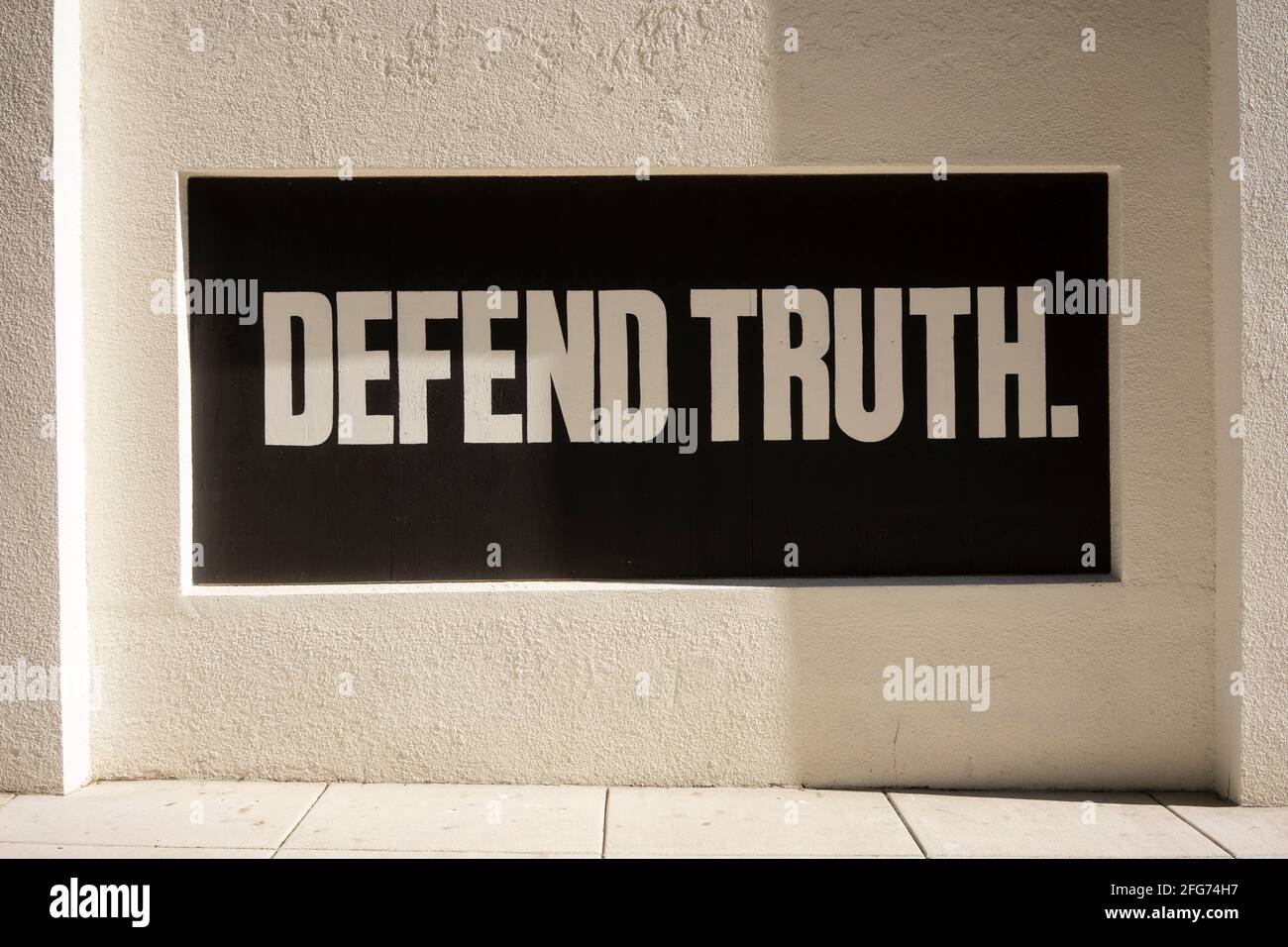 Defend Truth. Positive slogan painted on boarded-up window during protests. Stock Photo