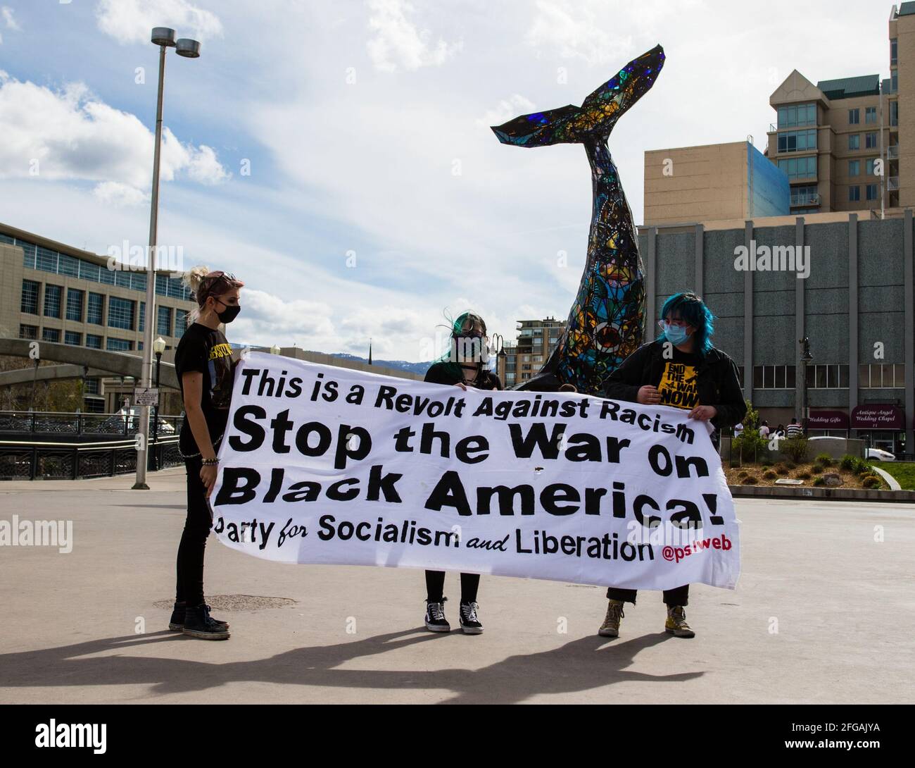 Reno, United States. 24th Apr, 2021. Protestors display a large banner during the protest at the city plaza. Protests gather for an Anti-Police Violence event hosted by the party for Socialism and Liberation. The protest remained peaceful but did encounter hecklers. Credit: SOPA Images Limited/Alamy Live News Stock Photo