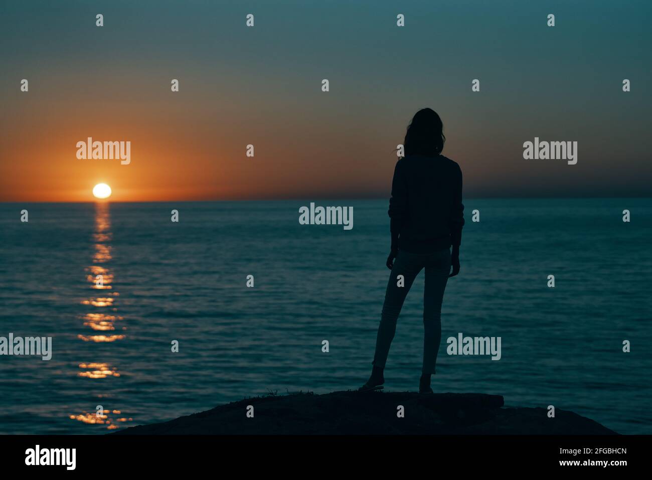 woman at sunset sea silhouette on the shore and beach sky Stock Photo ...
