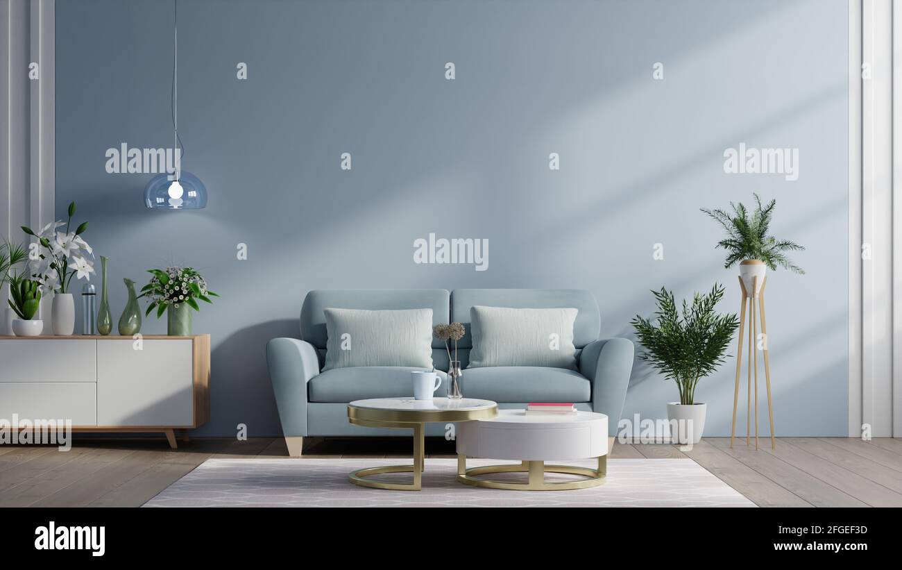 Modern living room interior with sofa and green plants,lamp,table on dark blue wall background. 3d rendering Stock Photo