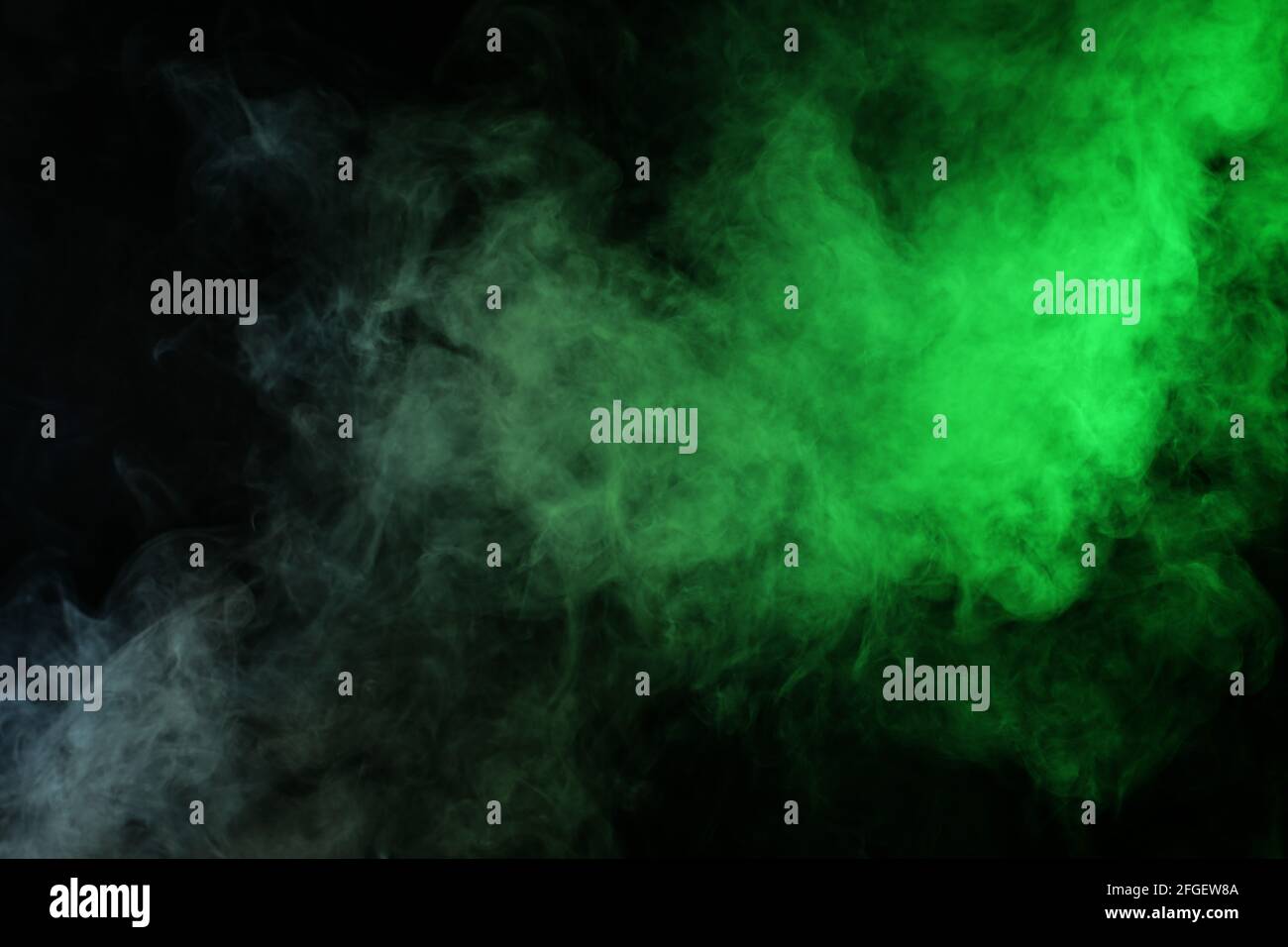 Smoke in red-green light on black background Stock Photo