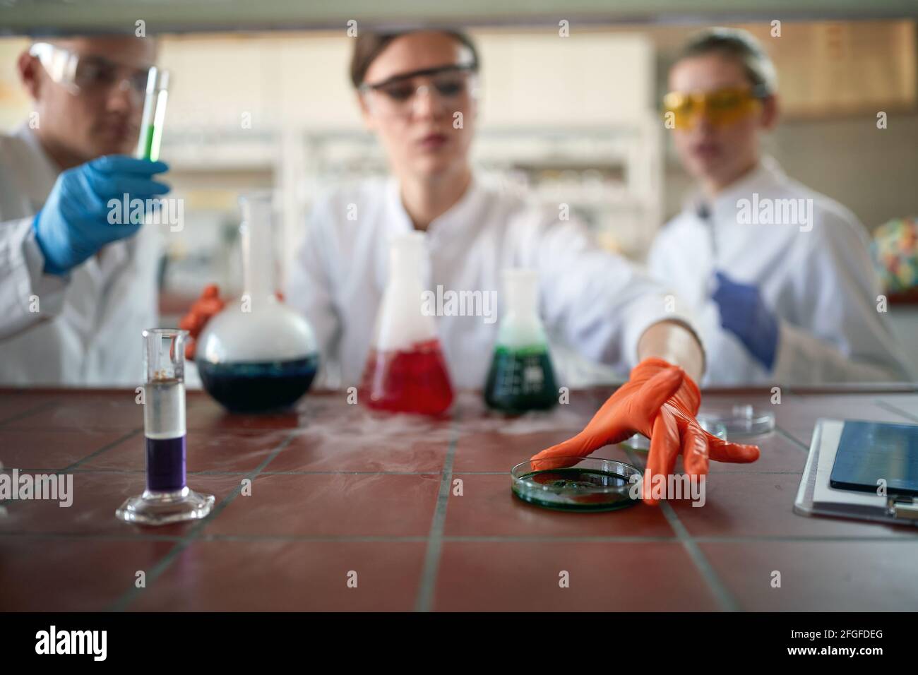 Young chemistry students in a working atmosphere in the university laboratory do an experiment. Science, chemistry, lab, people Stock Photo