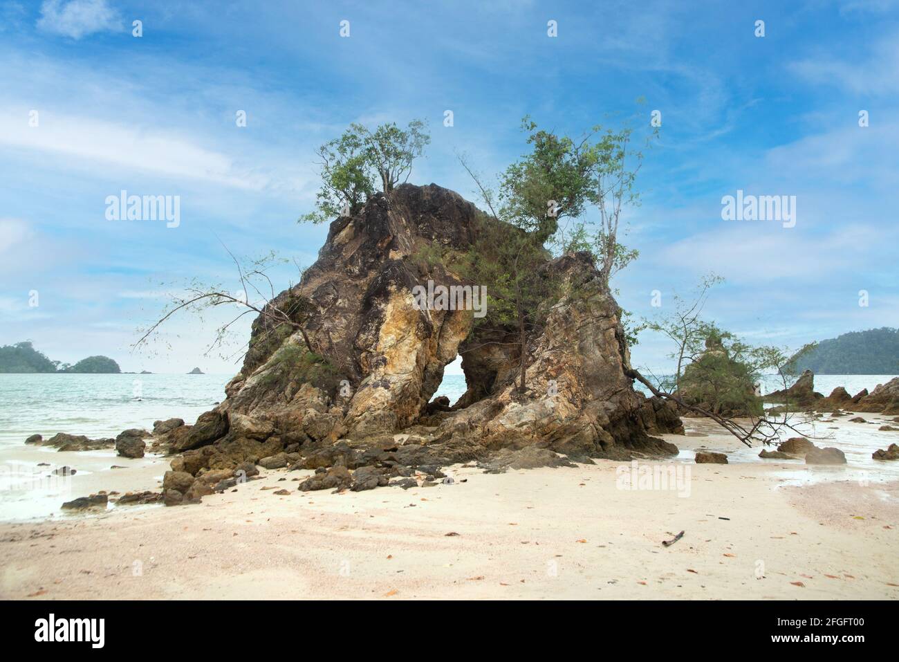 A rocky beach with a view of the rock with holes and the sea. Rocky ...