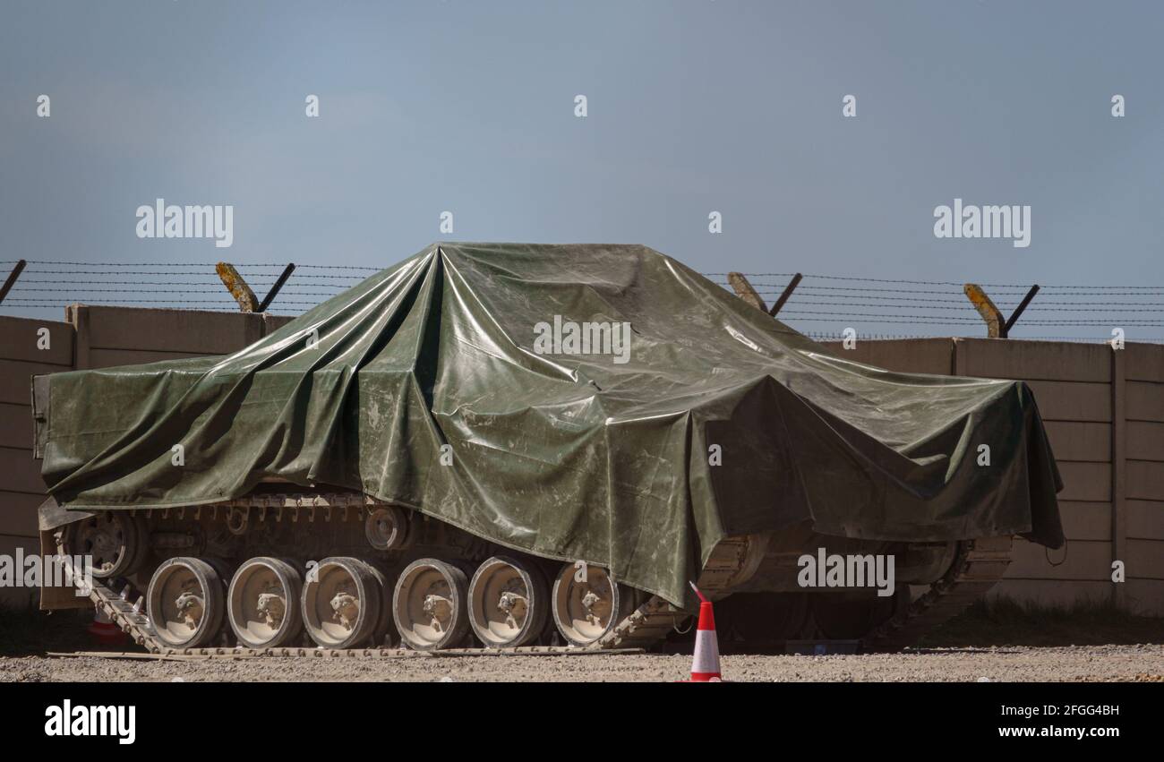 british army warrior FV510 light infantry vehicle under tarpaulin awaiting maintenance and repairs Stock Photo