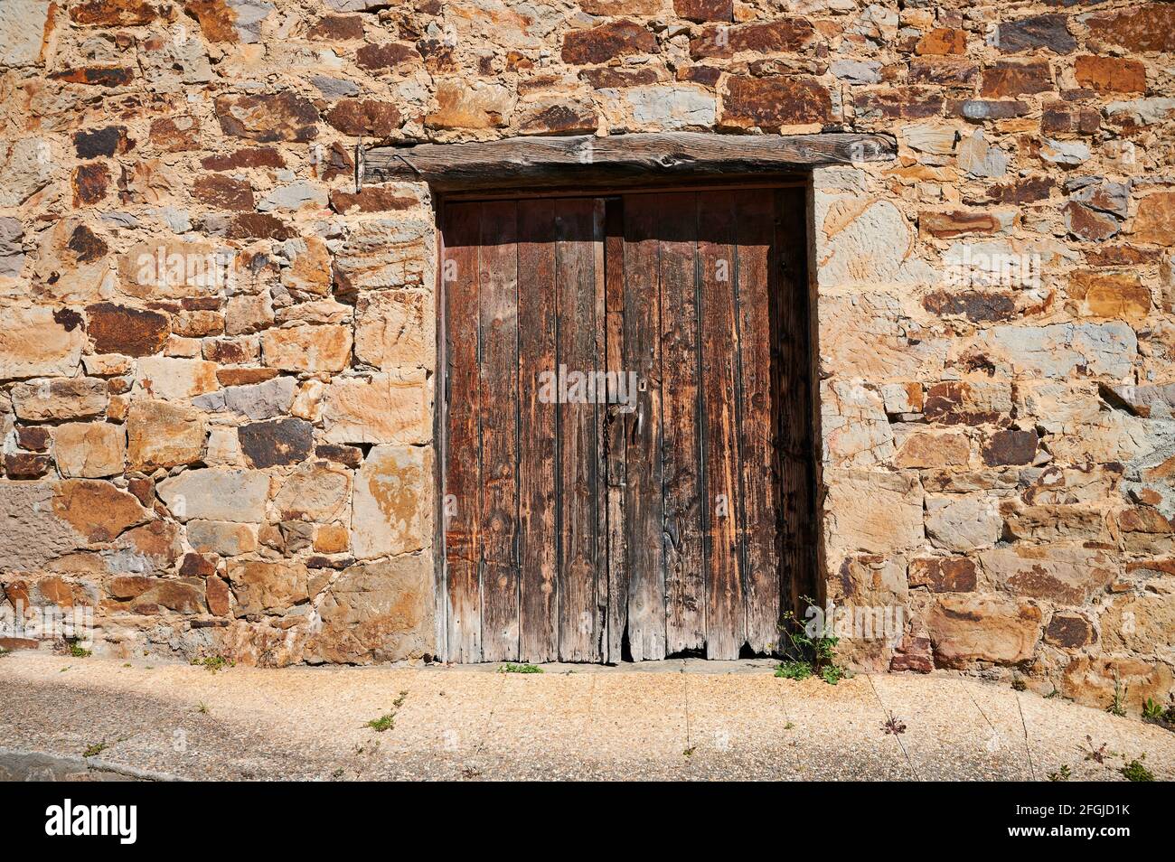 Old wooden door in the stone wall Stock Photo - Alamy
