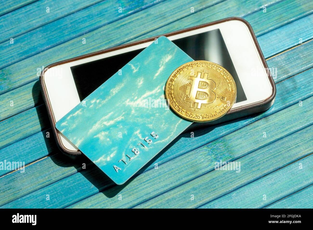 Bitcoin gold coin and a gift card, credit card laying on top of a modern  smartphone screen. BTC blockchain payments, mobile portable storing and  payme Stock Photo - Alamy