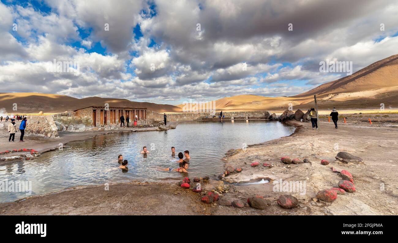 San Pedro de Atacama, Chile - october 14, 2019: people relax with a bath in a Natural hot spring pool at an altitude of 4300m, El Tatio Geysers, Ataca Stock Photo