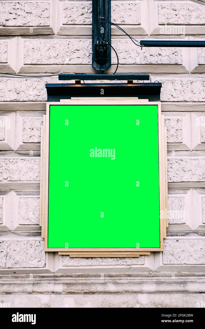 Plaque with blank background hanging on brick building Stock Photo