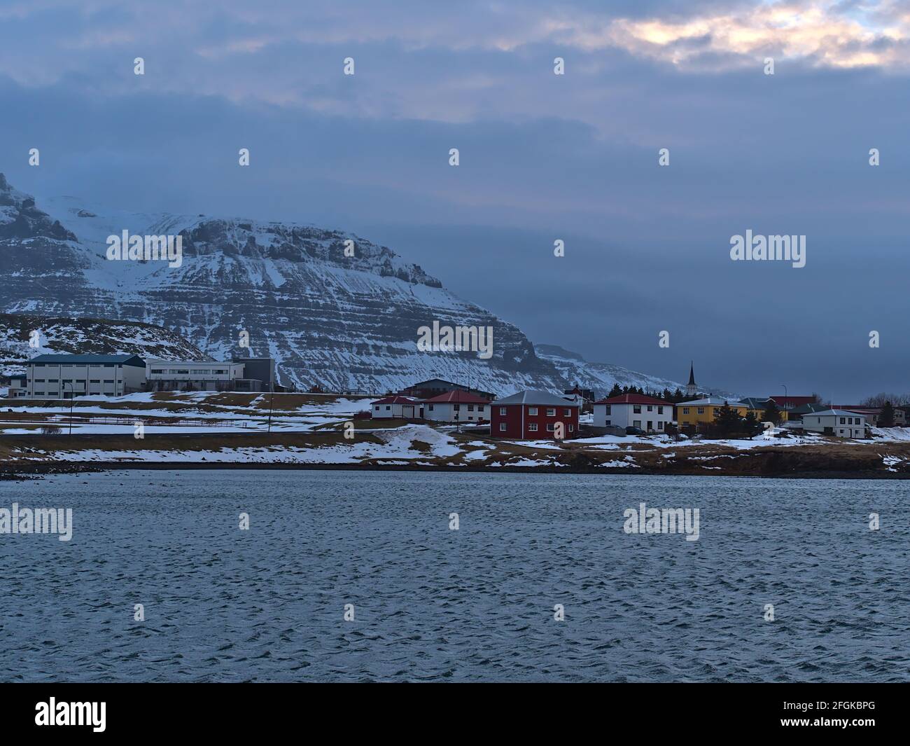 View of small village Grundarfjörður on the northern Atlantic coast of Snæfellsnes peninsula, Iceland with church and buildings in front mountain. Stock Photo