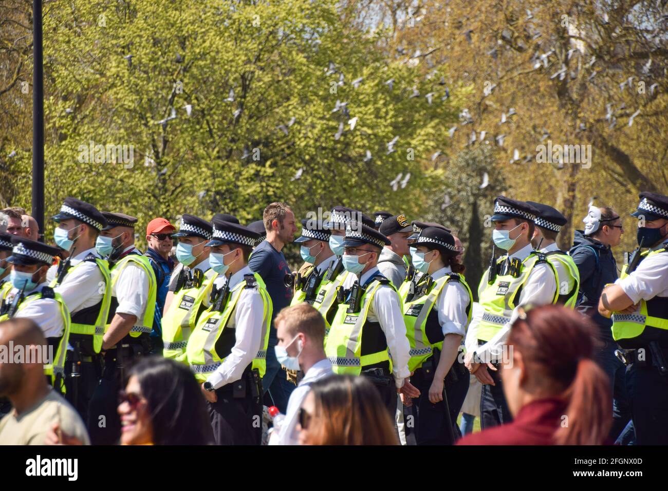 London, United Kingdom. 24th April 2021. Police wearing protective face masks at the anti-lockdown protest. Thousands of people marched through Central London in protest against health passports, protective masks, Covid vaccines and lockdown restrictions. Stock Photo