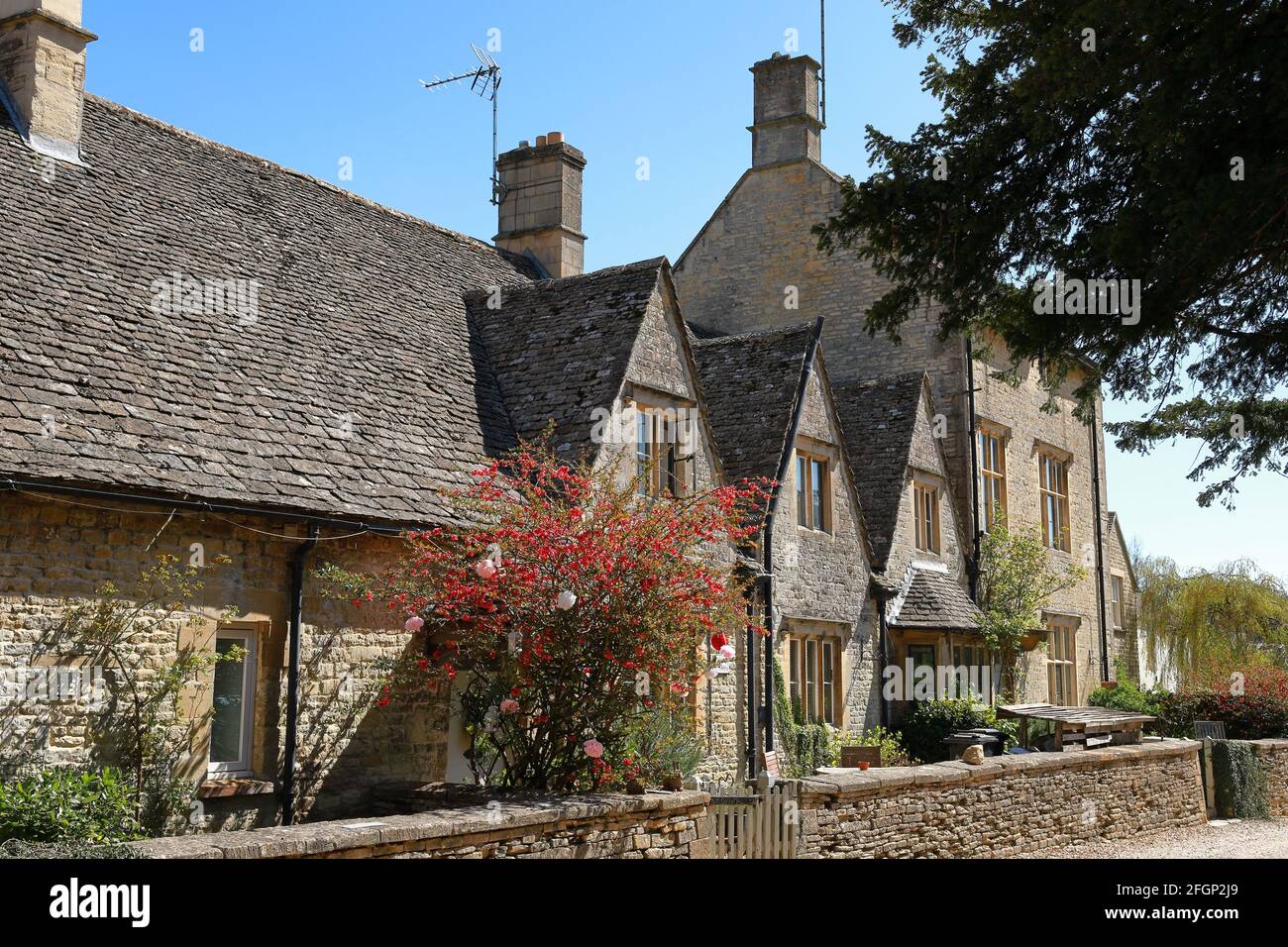 A row of traditionally built pretty Cotswold stone cottages in the Cotswold town of Northleach in Gloucestershire Stock Photo