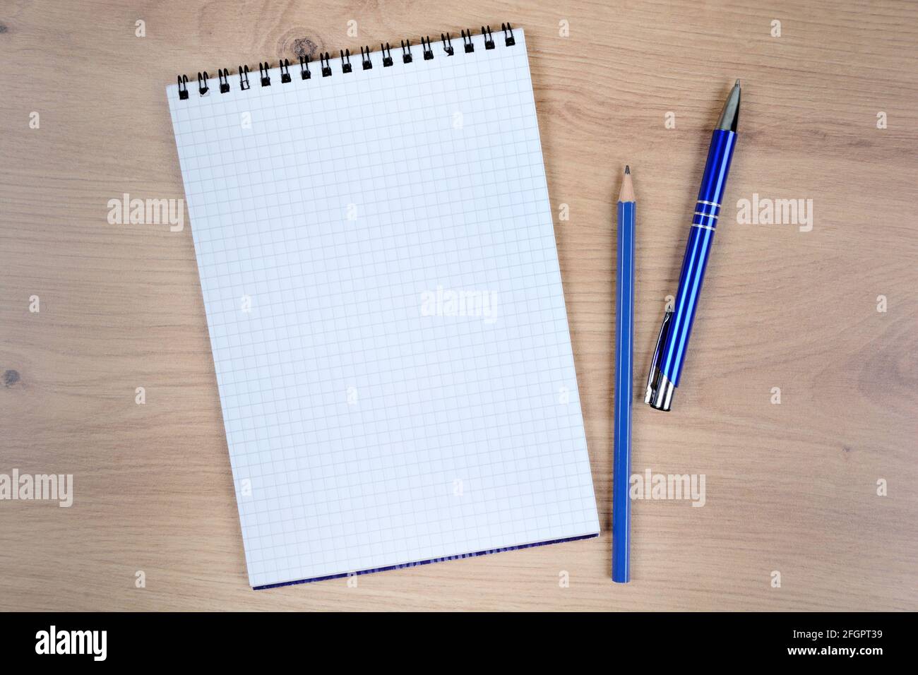Empty notebook with pen and pencil on a wood table. Top view Stock Photo