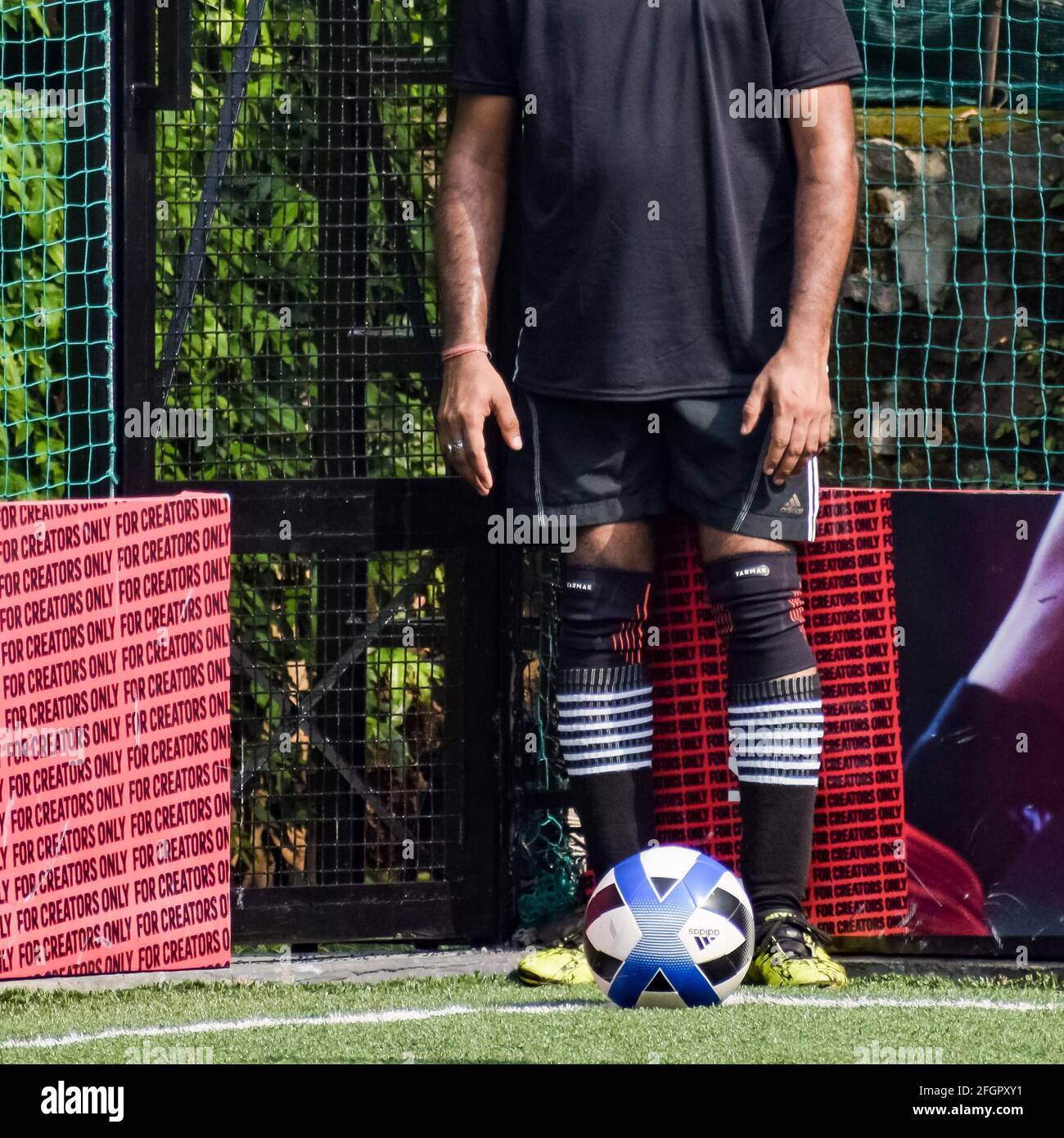 New Delhi, India - July 19 2019: Footballers of local football team during game in regional Derby championship on a bad football pitch. Hot moment of Stock Photo