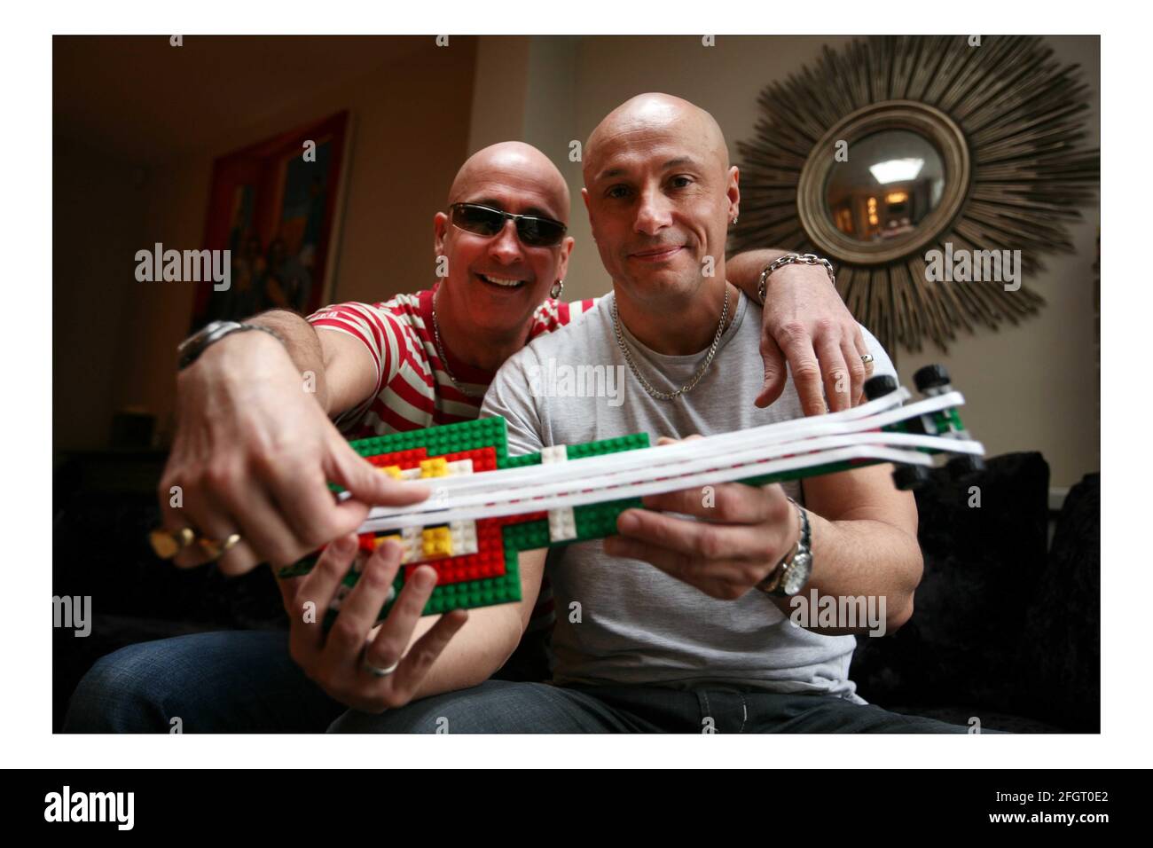 LEGO..... 'Right Said Fred' Fred (grey T shirt) and Richard (red stripe T shirt)  Fairbrass with their LEGO guitar at home in west London  pic David Sandison Stock Photo