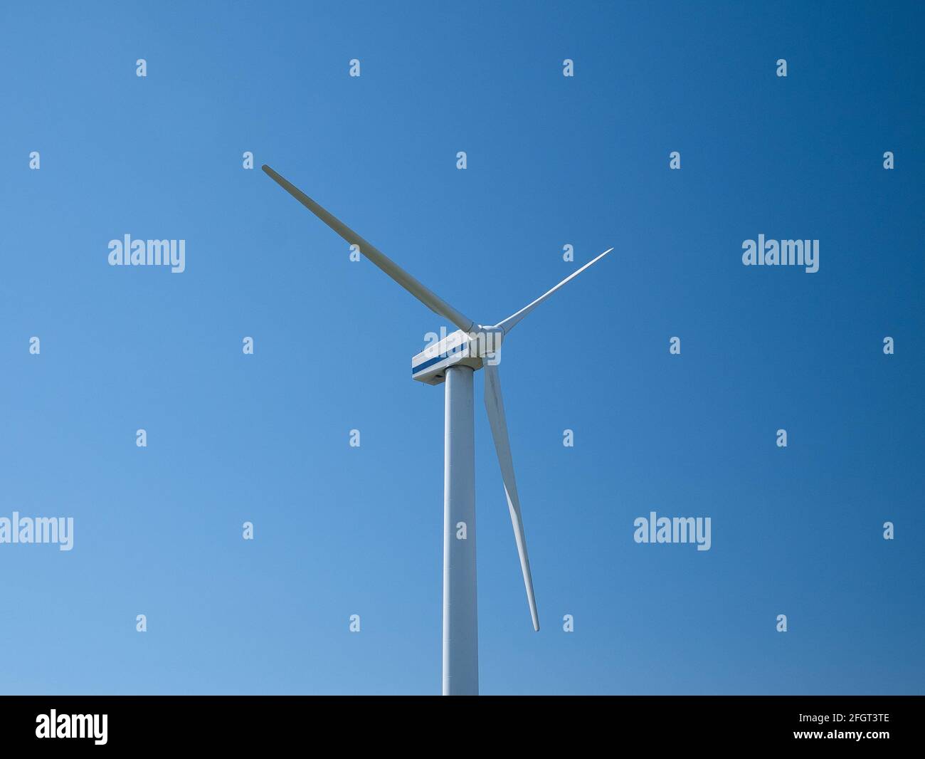 A wind turbine near Workington on the Solway Coast, Cumbria, UK. Taken on a sunny day with a clear blue sky. Stock Photo