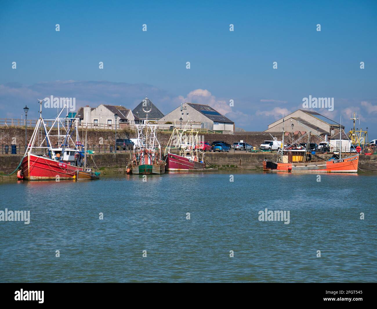Fishing boats moored at Maryport on the Solway Coast in Cumbria, UK. Taken on a sunny day in spring. Stock Photo
