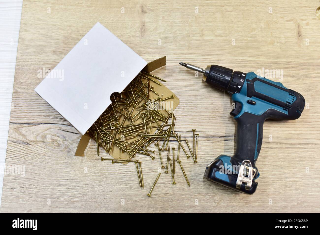 Cordless combi drill for used as normal drill impact drill and screw driver. Cordless impact screwdriver and self tapping screws for wood in a cardbo Stock Photo Alamy