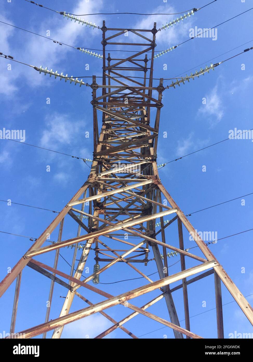 power line against a blue sky. high voltage tower. bottom-up view Stock ...