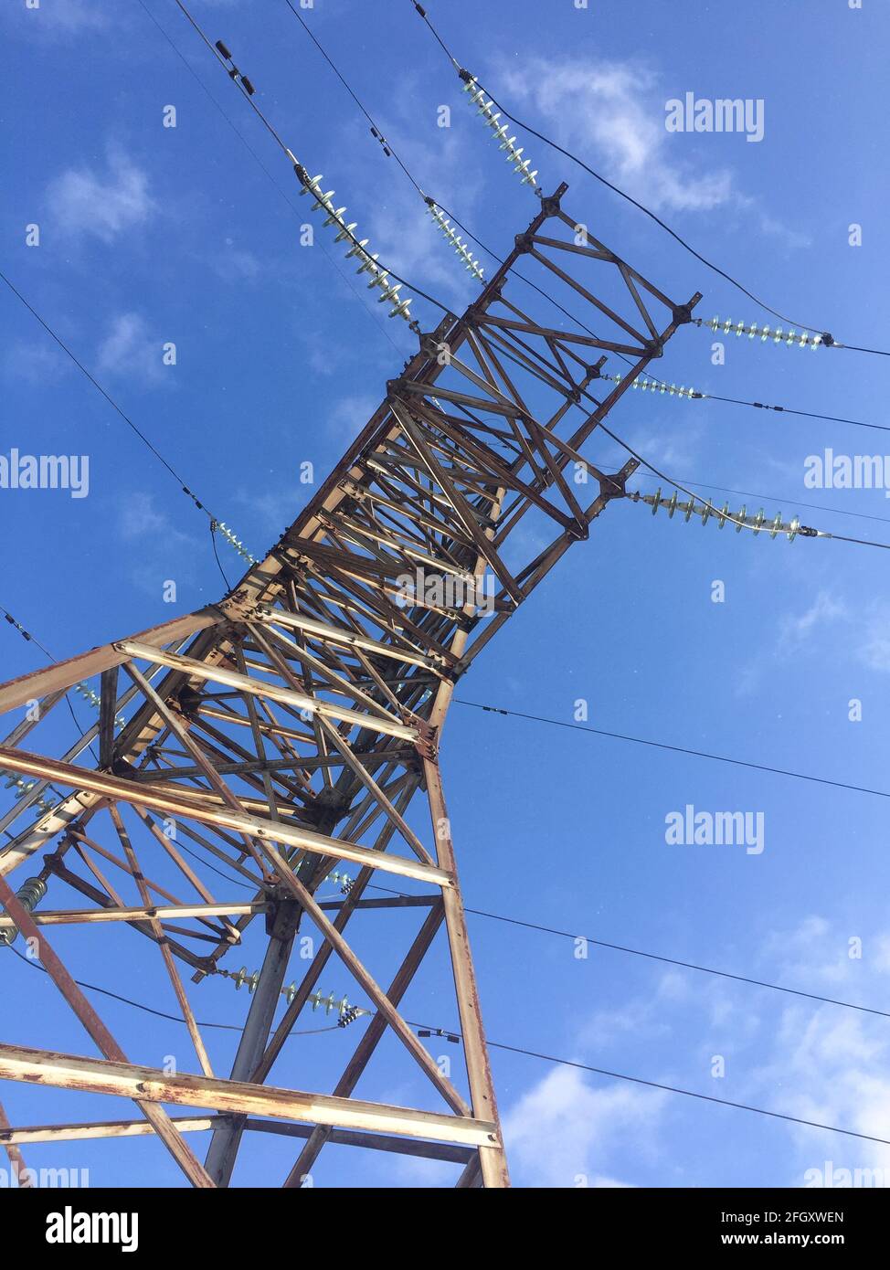 power line against a blue sky. high voltage tower. bottom-up view Stock ...