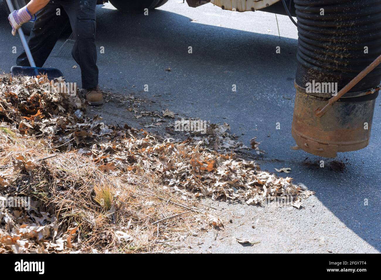 Man using vacuum for cleaning leaf of the road autumn season Stock Photo