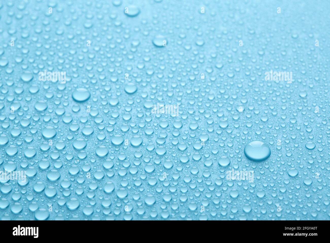 Pure water drops on blue abstract background or texture. Stock Photo