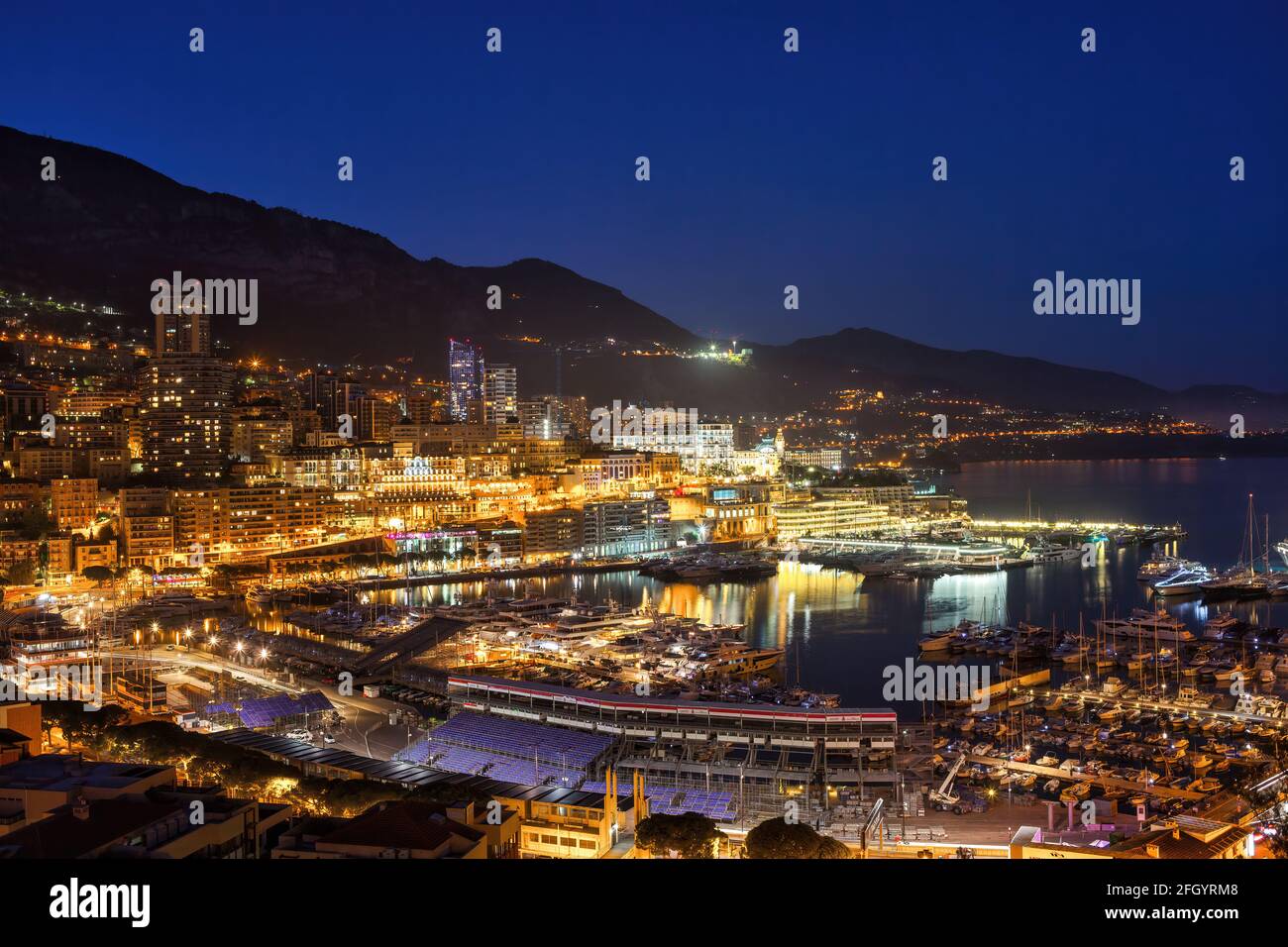 Principality of Monaco night cityscape with Port Hercule. Stock Photo