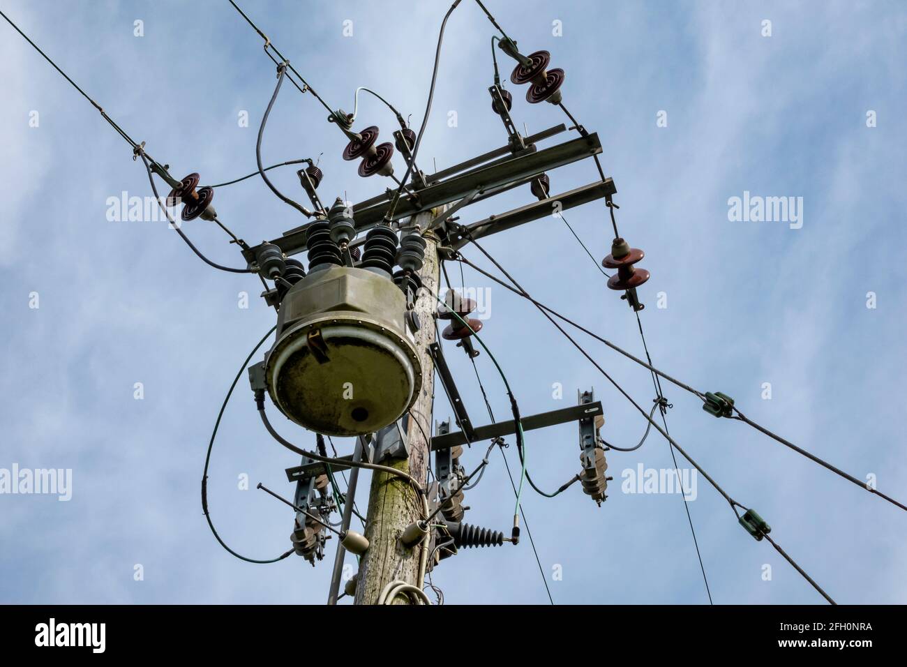 Wooden power pole with electric lines and GVR recloser switchgear Stock Photo