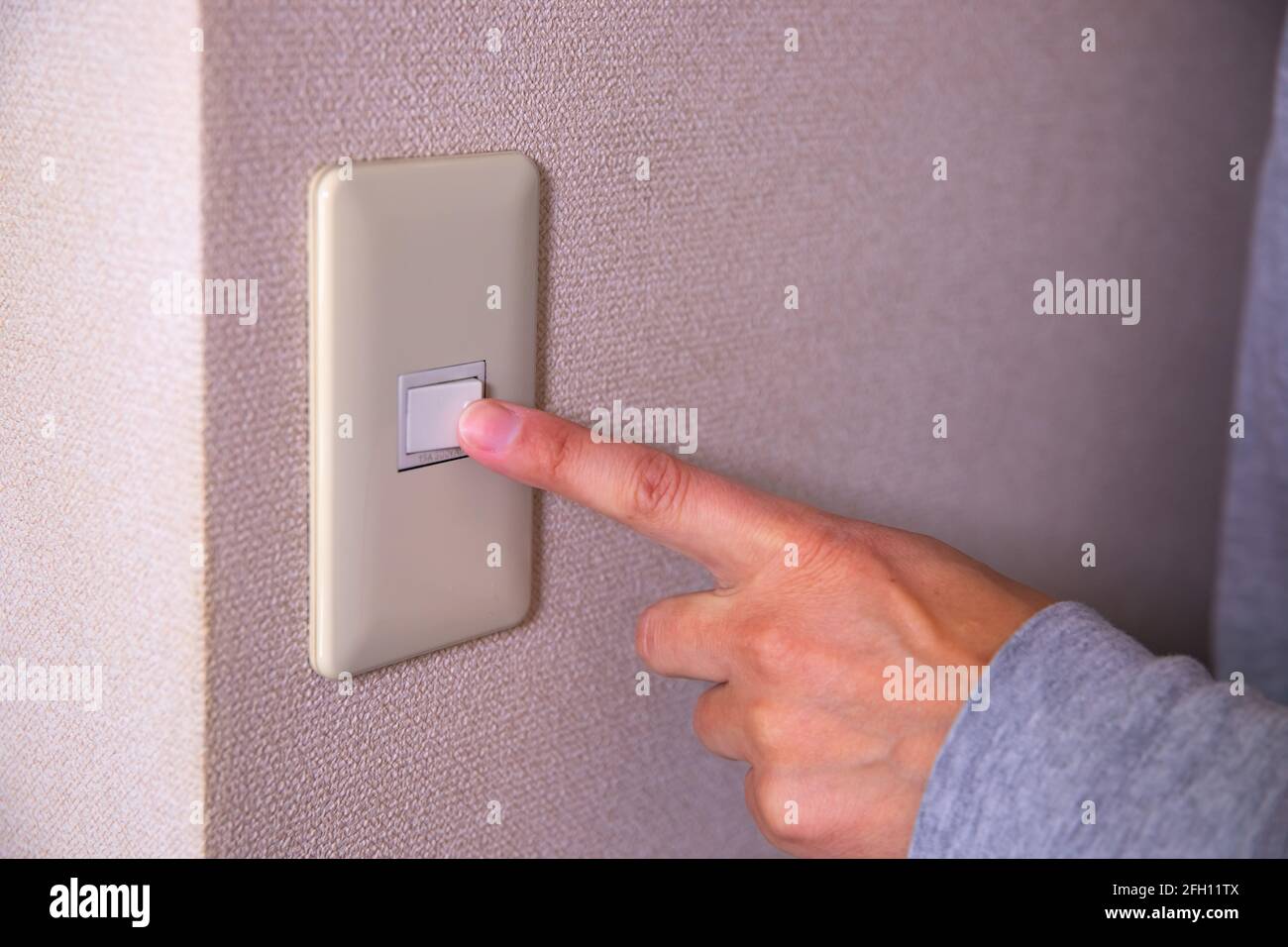 Light switch pushing by male hand daytime closeup Stock Photo Alamy