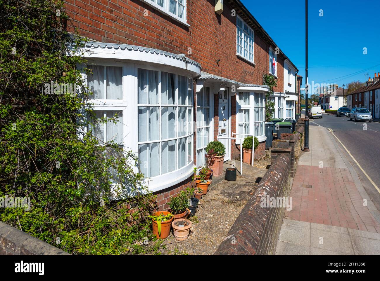 Row of modern 2 storey terraced houses with lower floor double glazed bay windows at number 54-62 North Street in Emsworth, Hampshire, England, UK. Stock Photo