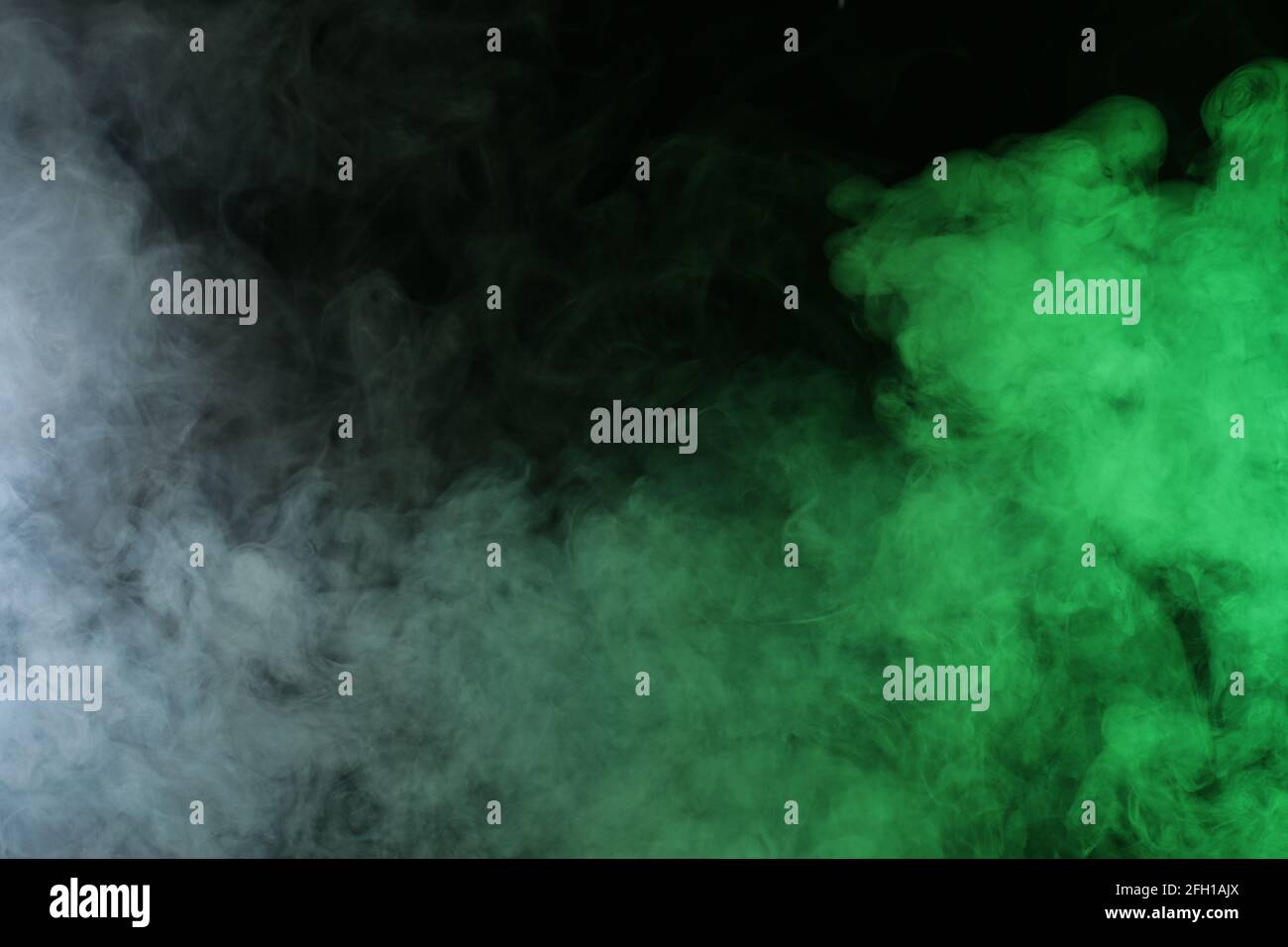 Smoke in red-green light on black background Stock Photo