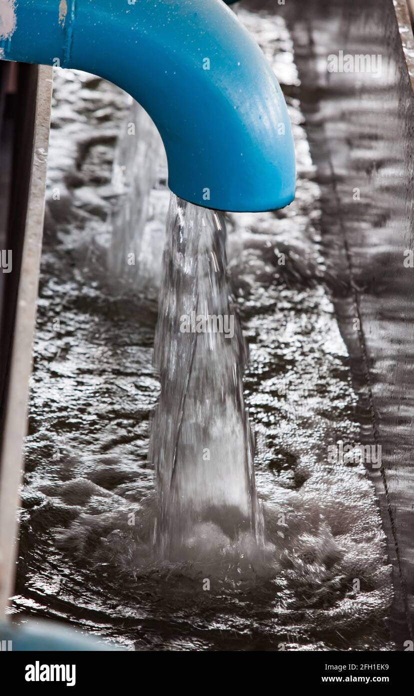 Water purification station. Low depth of field. Blue pipes and flow