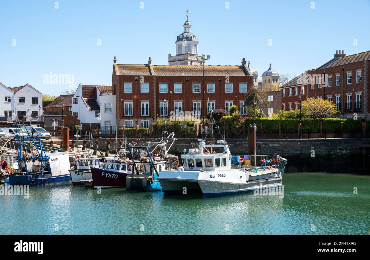 Old Portsmouth, England, UK. 2021.  The Camber docks for fishing vessels in Old Portsmouth, southern England, Portsmouth Cathedral in the background. Stock Photo