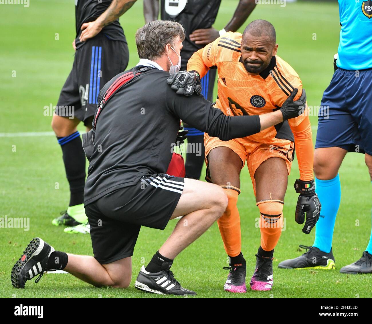 Nashville, TN, USA. 24th Apr, 2021. Montreal goalkeeper, Clement Diop (23), is helped up after being injured during the MLS match between CF Montreal and Nashville SC at Nissan Stadium in Nashville, TN. Kevin Langley/CSM/Alamy Live News Stock Photo