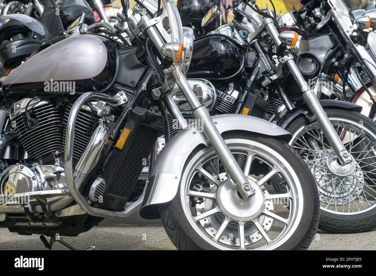 Motorcycles parked on the motorcycles parking lot. Closeup of motorcycles front wheel. Stock Photo