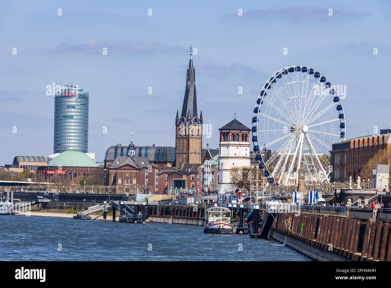 View of the Rhine embankment, Ergo insurance, Schlossturm tower and historic buildings with ferris wheel in Düsseldorf, Germany Stock Photo