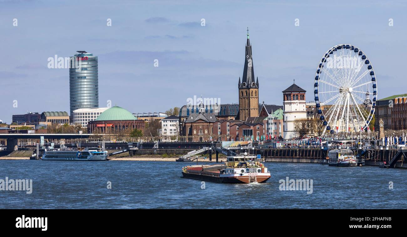 View of the Rhine embankment, Ergo insurance, Schlossturm tower and historic buildings with ferris wheel in Düsseldorf, Germany Stock Photo