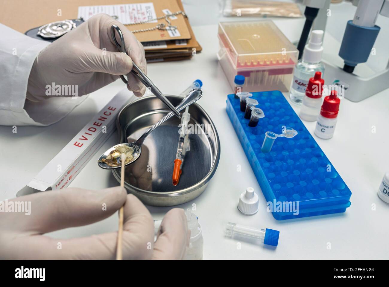 Police scientist holding spoon used in crime lab overdose case, conceptual image Stock Photo