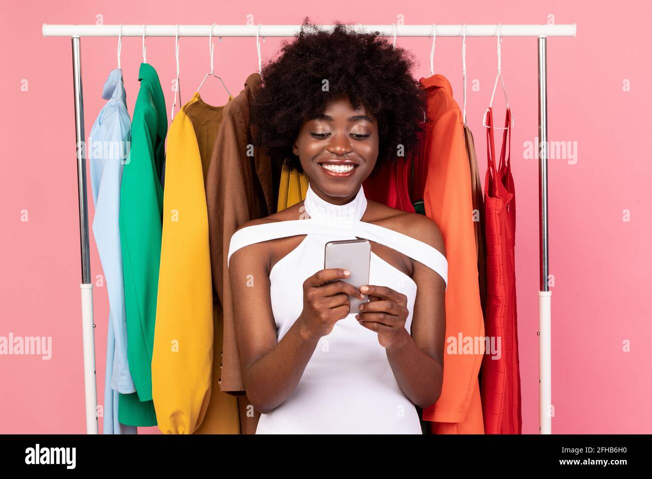 Happy Black Female With Smartphone Buying Clothes Online, Studio Shot Stock Photo