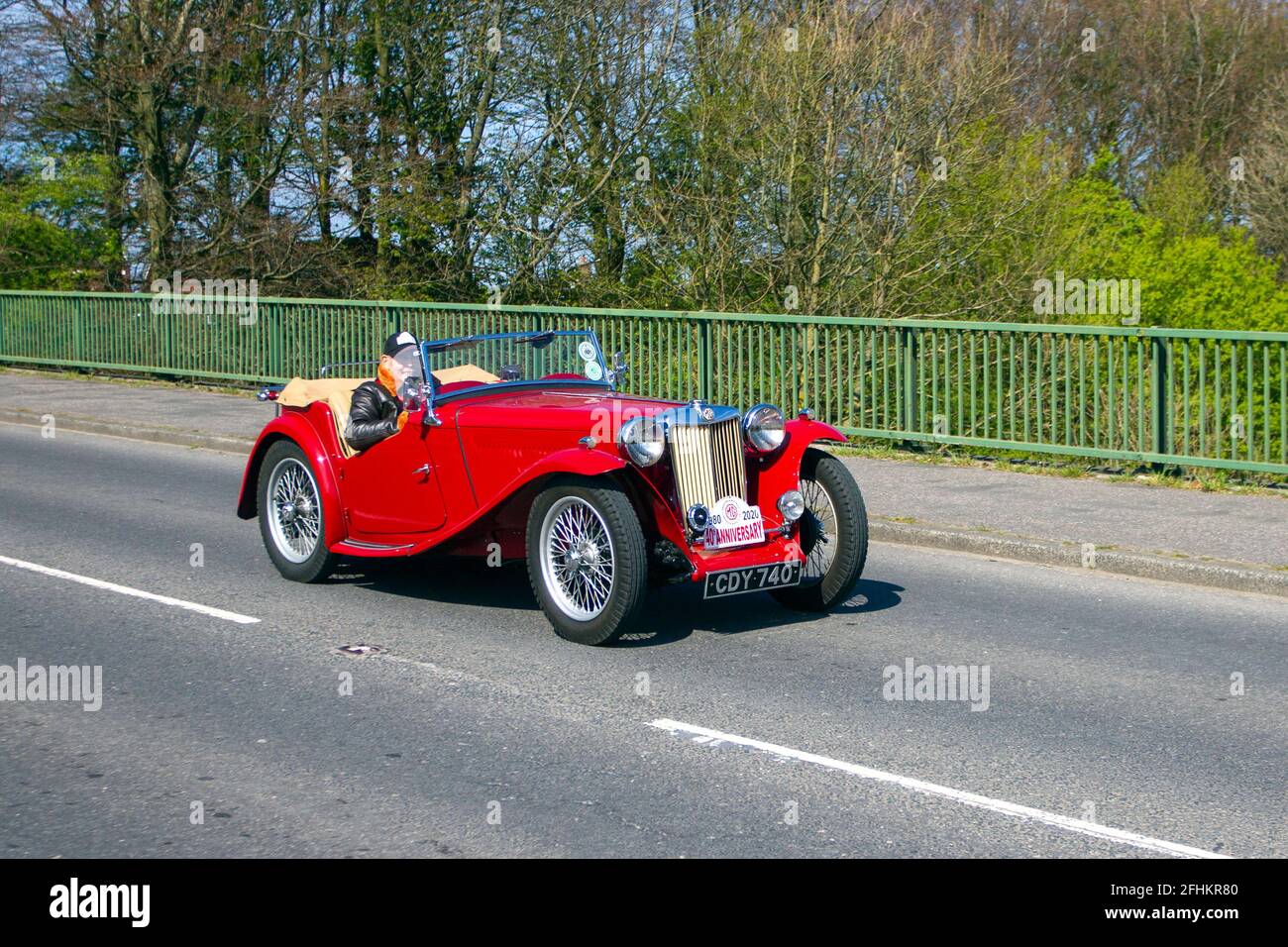 1947 40s MG red 1250cc roadster; moving vehicles, cars, vehicle driving,  roads, motors, motoring, UK road network. Stock Photo