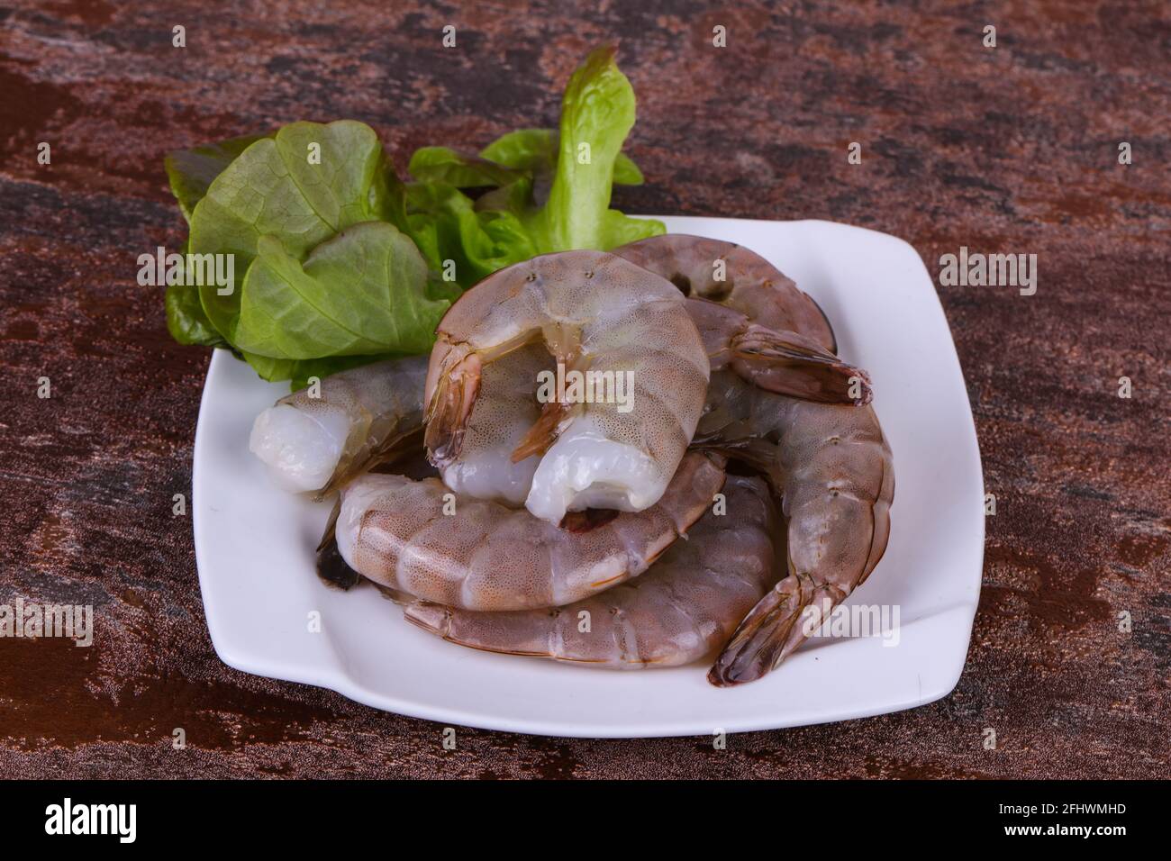 Raw king prawns ready for cooking served salad leaves Stock Photo Alamy