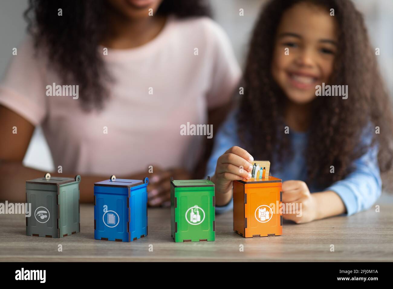 Eco education concept. African American woman playing environmental board game with her daughter, copy space Stock Photo