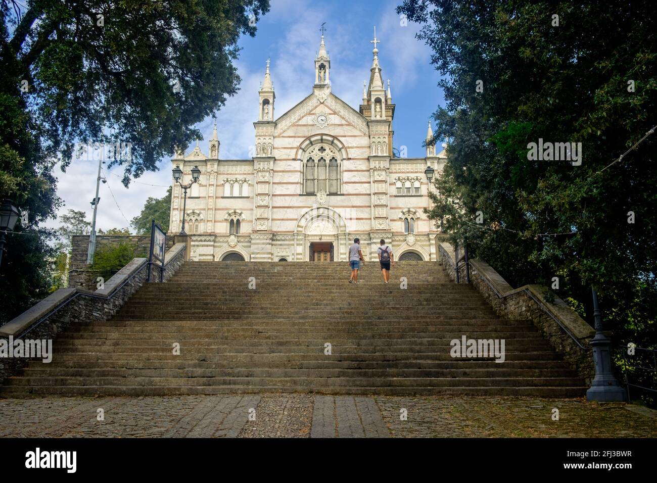 Stairs lead to the entrance of the Sanctuary of Our Lady Of Montallegro, a landmark near Rapallo. It has a marble front facade. Stock Photo