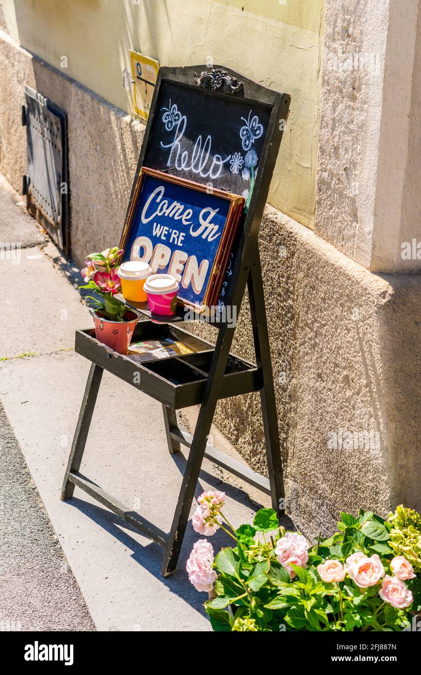 Budapest, Hungary - August 10, 2019: board hello come in we're open near local cafe in Budapest, Hungary Stock Photo