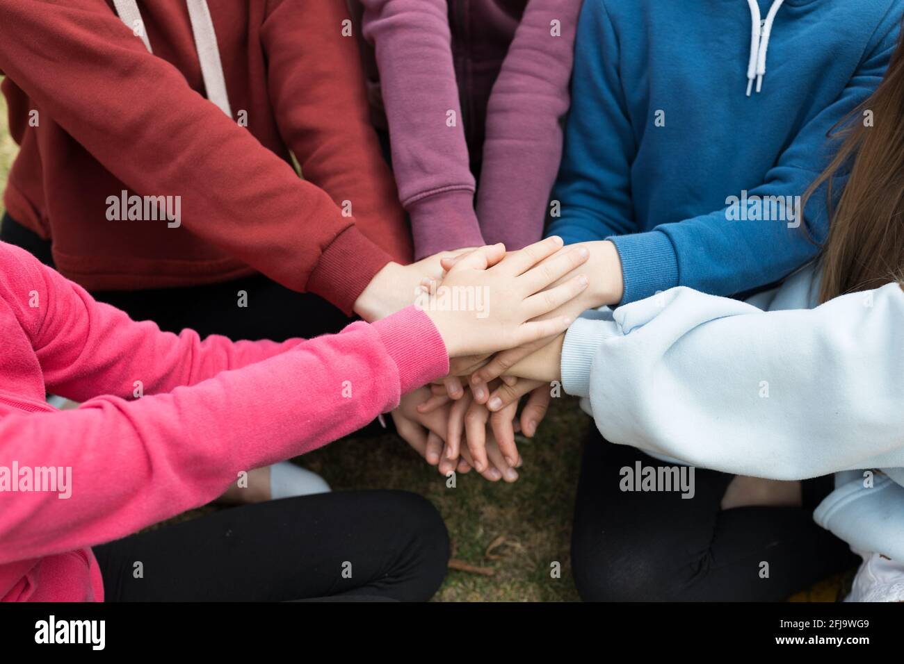 Stack of hands - young girls agreement Stock Photo