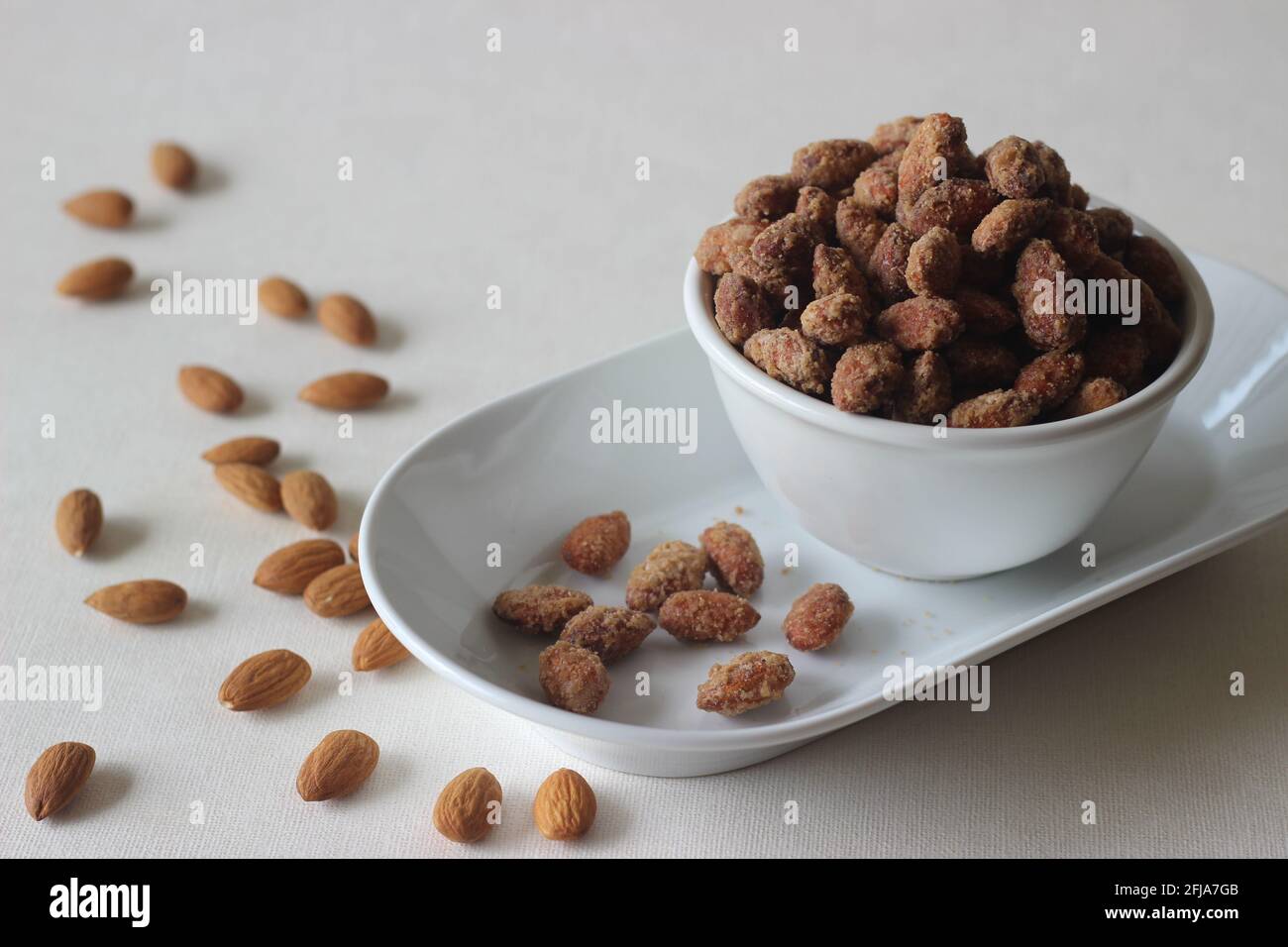 Candied almonds that are crunchy and golden brown. Shot on white background. Stock Photo