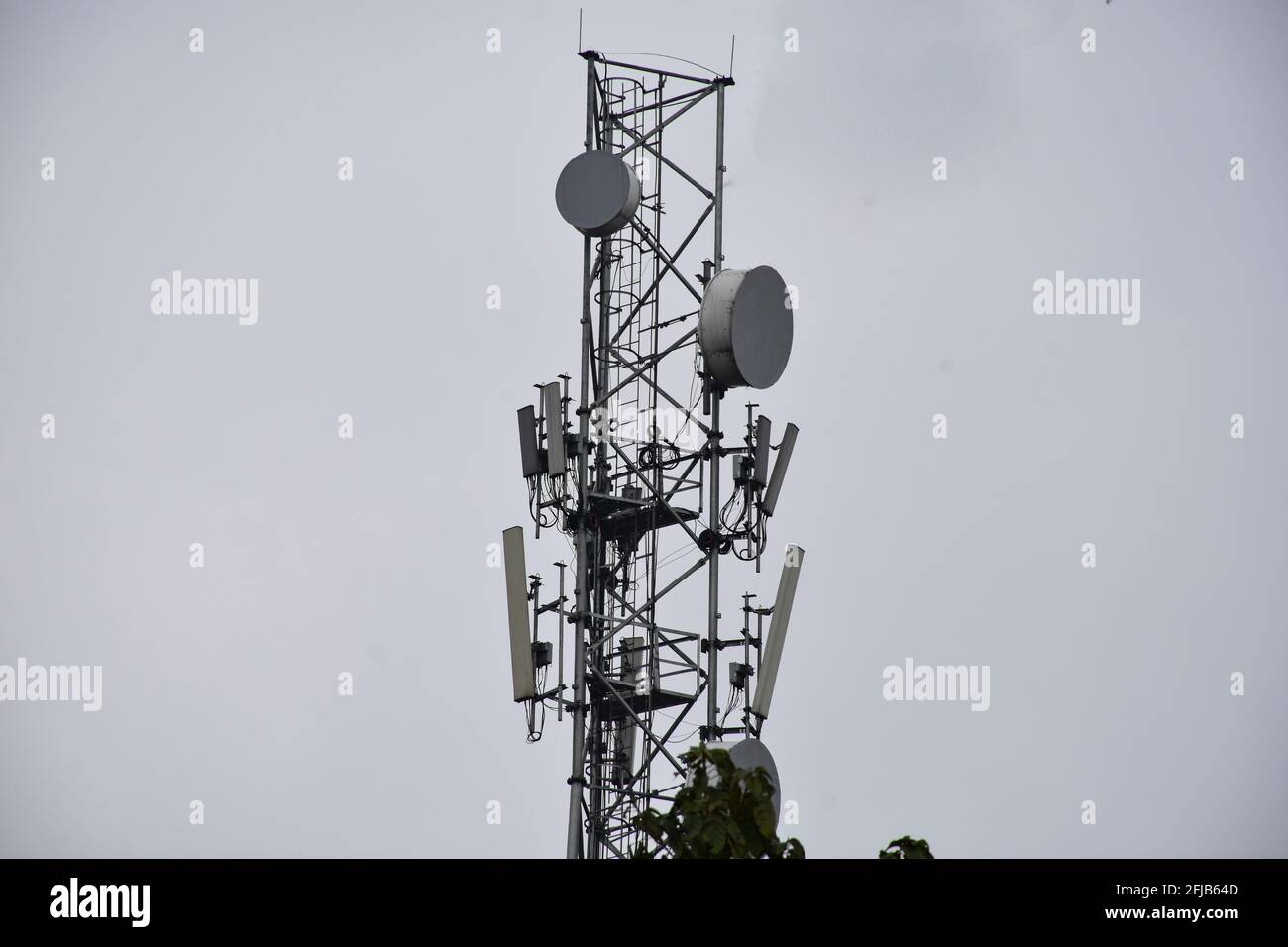 Mobile phone tower and cloudy sky . Stock Photo