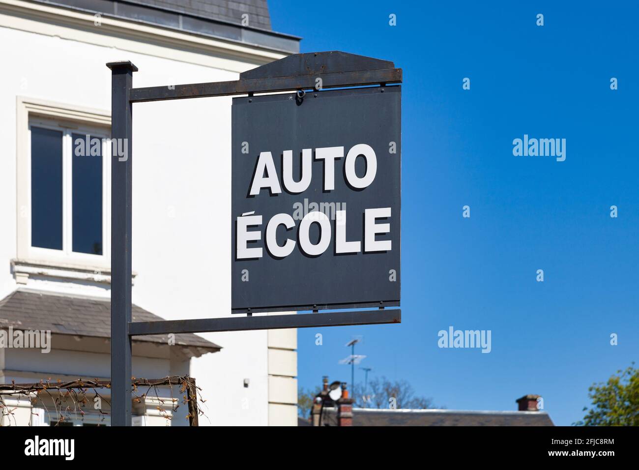 Outdoor sign with written in it in French 'Auto-École', meaning in English 'Driving school'. Stock Photo