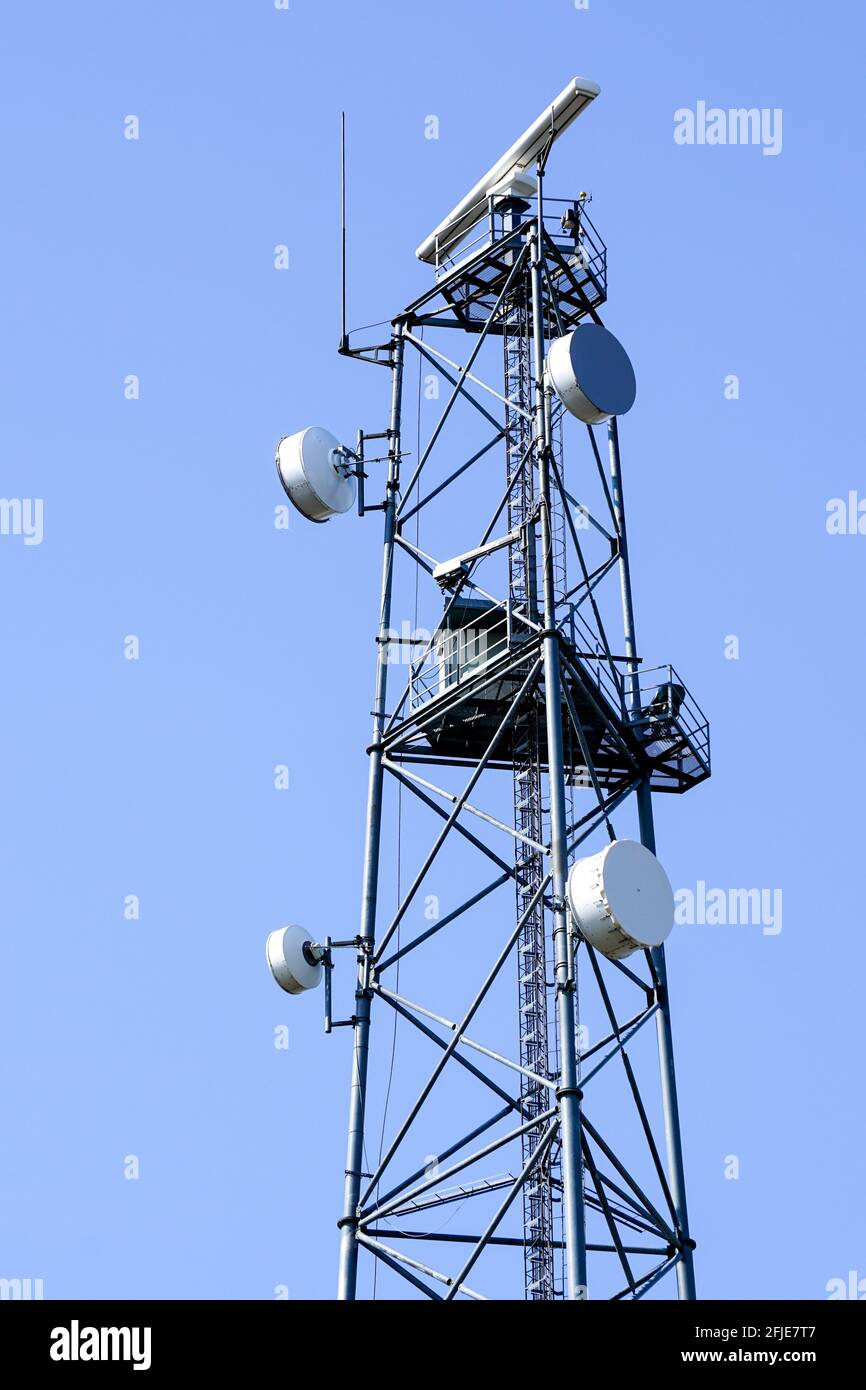 tower with coastal surveillance radar system and various communication  equipment on a blue sky background Stock Photo - Alamy