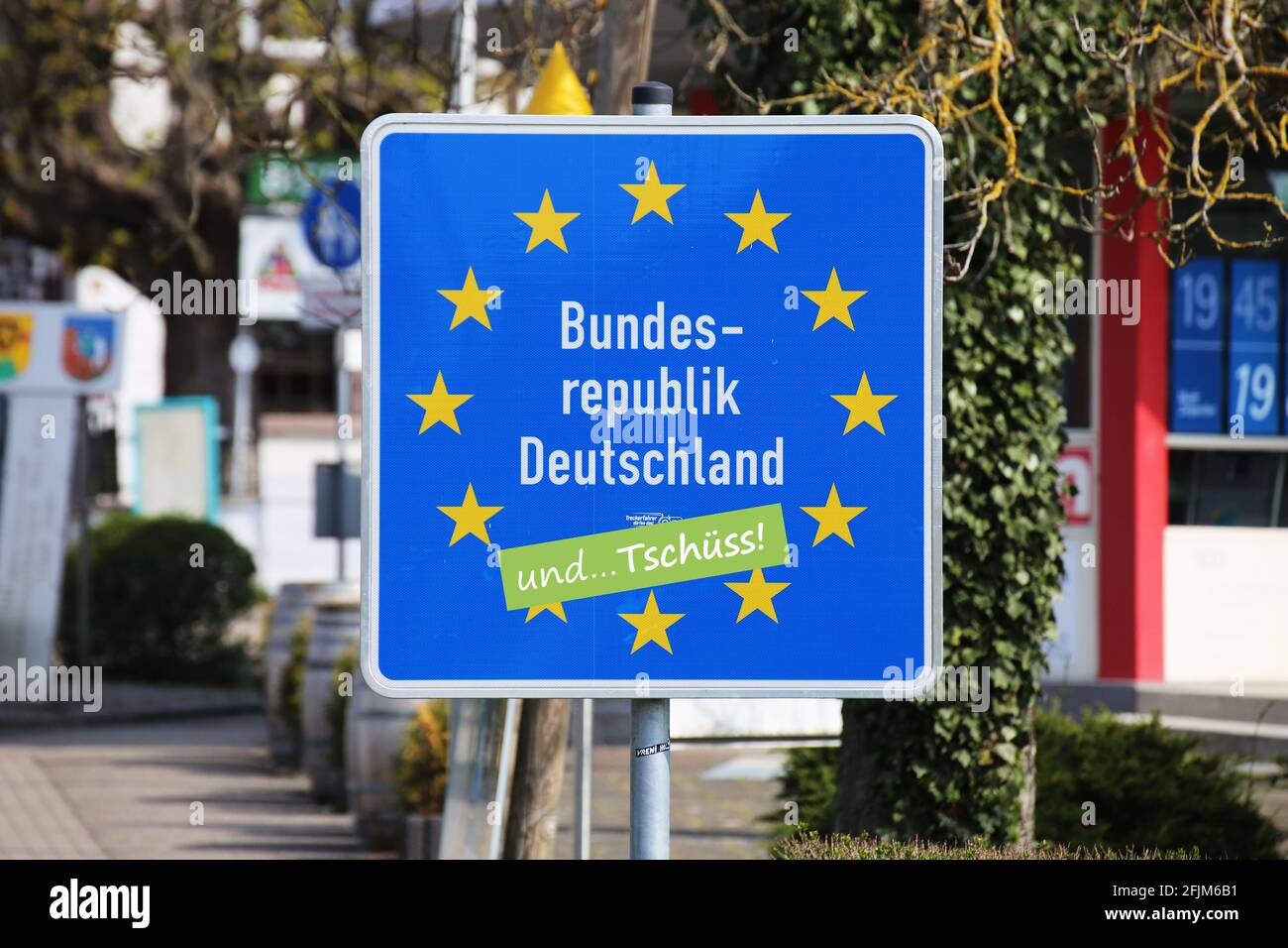 Symbolic image Emigration: Border sign of the Federal Republic of Germany with 'und tschüss' (goodbye) sticker Stock Photo