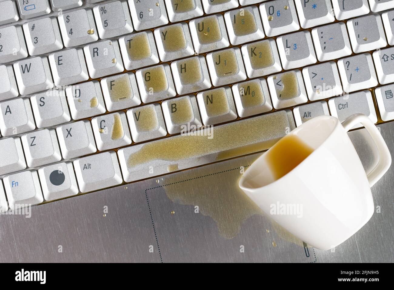 Coffee spilled on keyboard Stock Photo Alamy